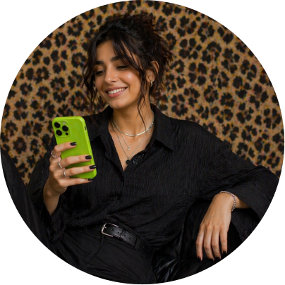 Egyptian young lady dressed in black looking at her phone